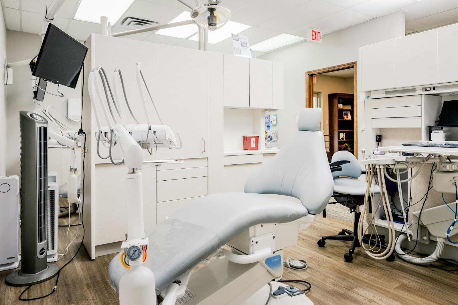 Treatment room with overhead light and monitor