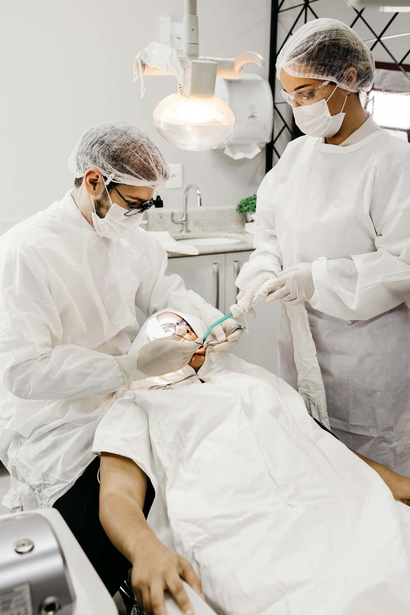 Two dentists carrying out a restorative procedure